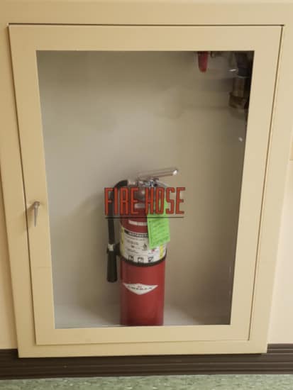 A mostly empty hose cabinet in a hospital